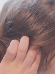 a girl washing her hair with toofruit shampoo