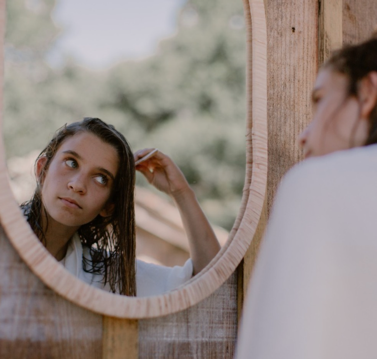 a girl combing her wet hair
