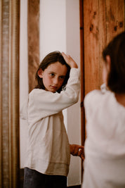 a boy using toofruit hair styling paste on his hair