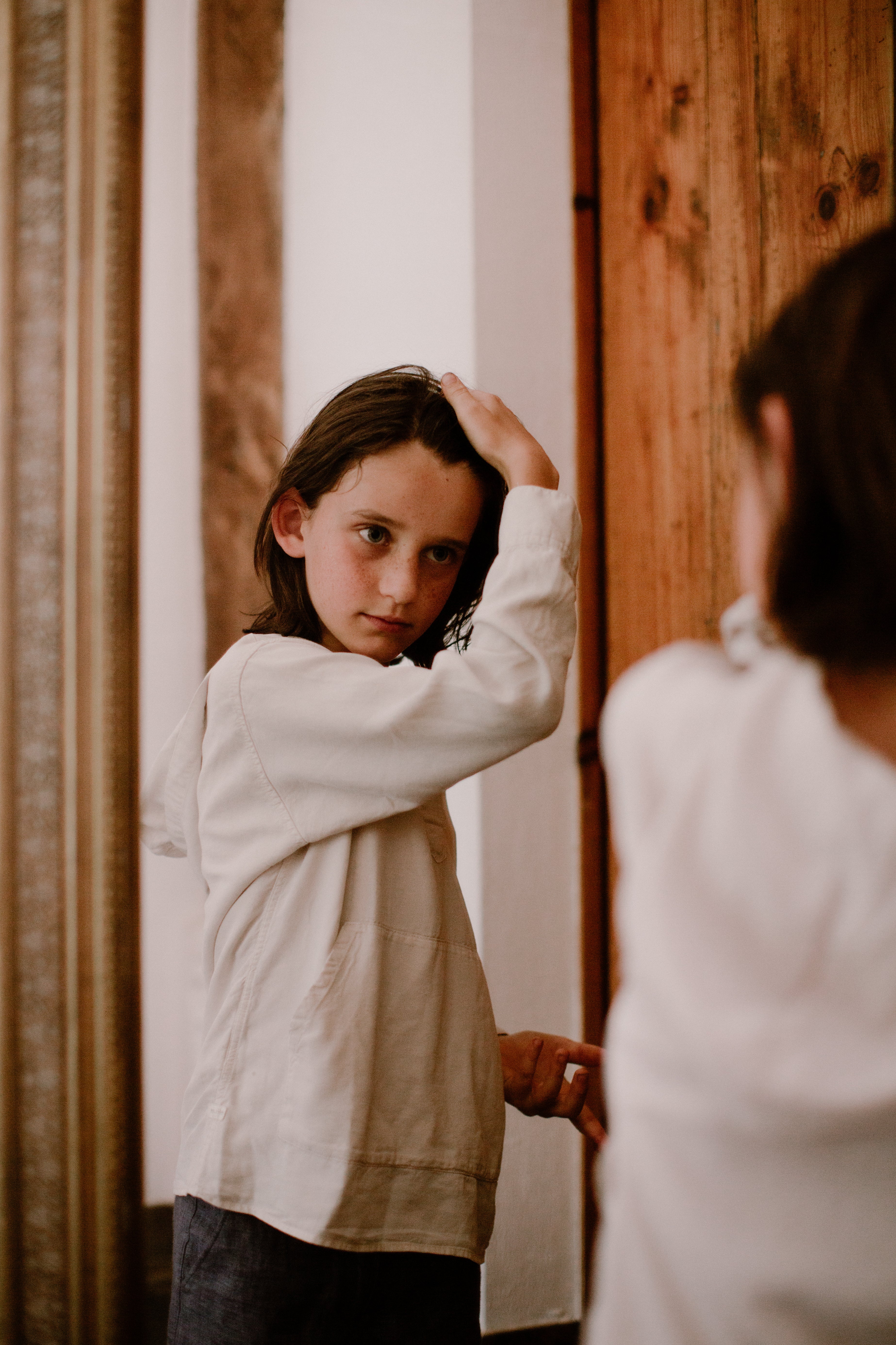 a boy using toofruit hair styling paste on his hair
