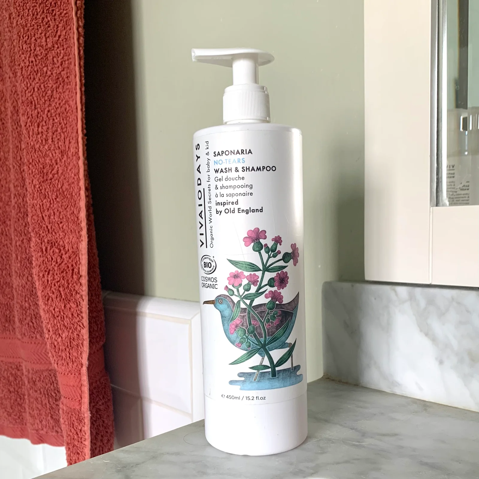 a bottle of saponaria shampoo with pump on the bathroom counter