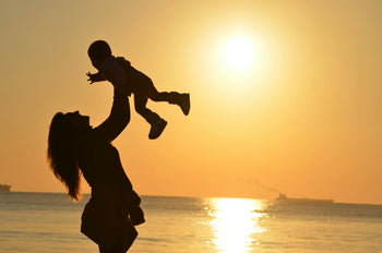 mum and kid with sunset