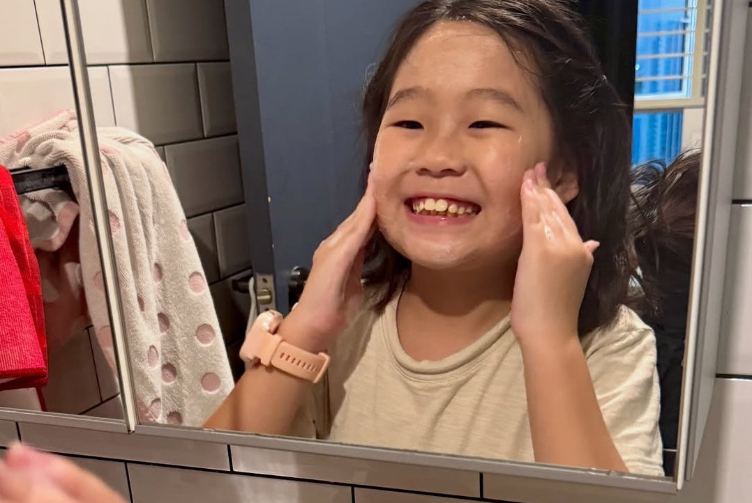 Pre-teen washing her face