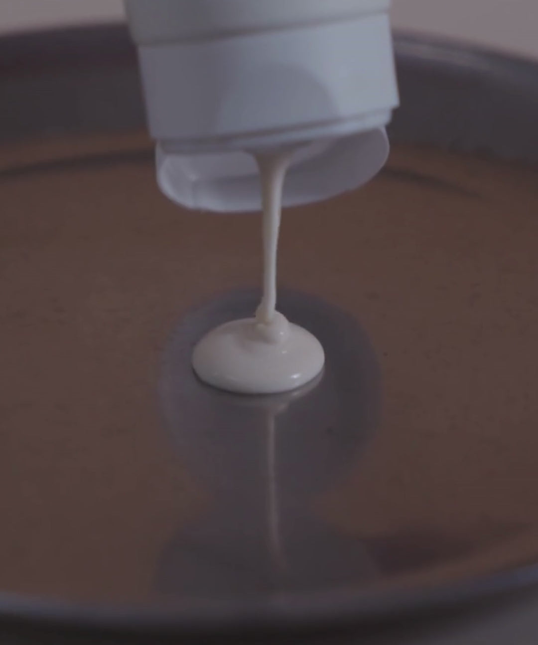 lait bodydoux being squeezed out on a metal surface