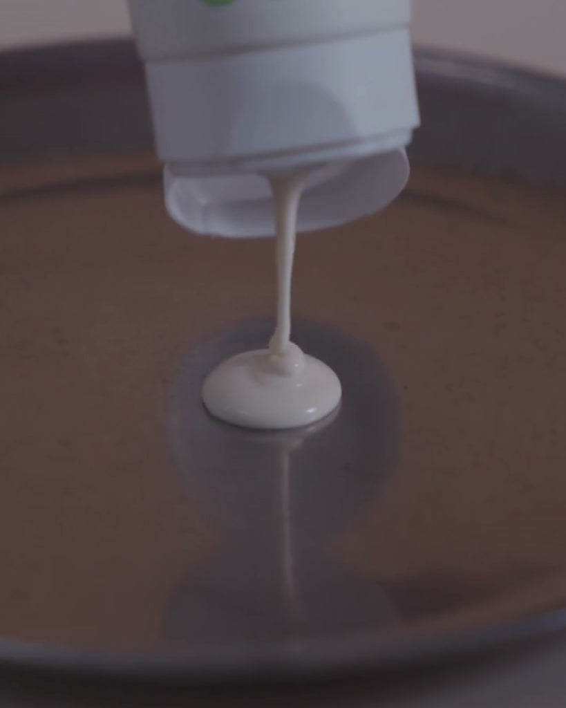 lait bodydoux being squeezed out on a metal surface