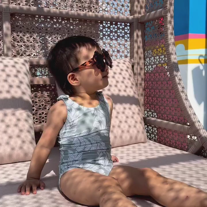 a video of a baby using vivaiodays turmeric sunscreen by the pool