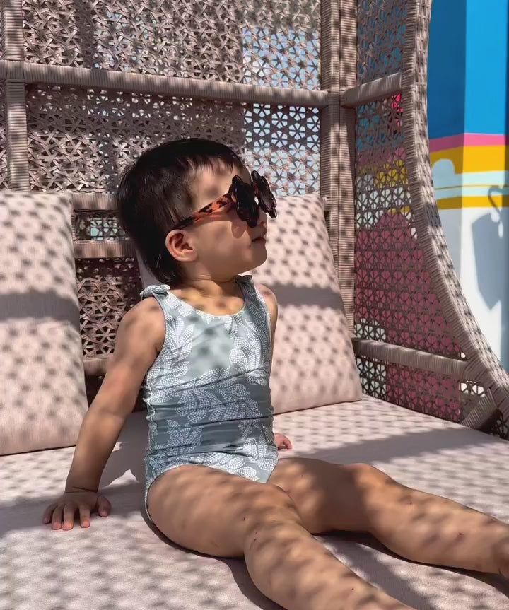 a video of a baby using vivaiodays turmeric sunscreen by the pool