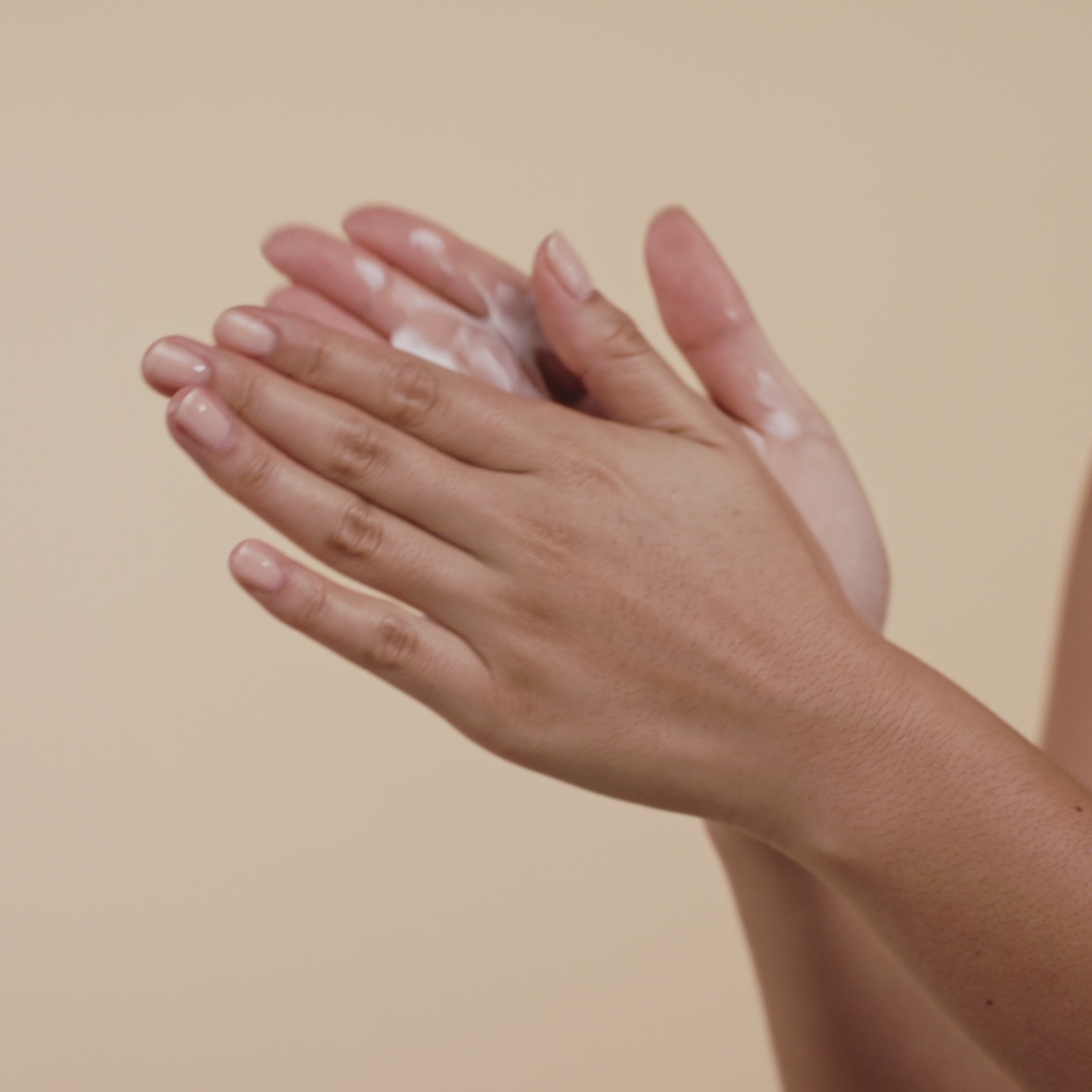 a video of a woman applying saya lotion on her body
