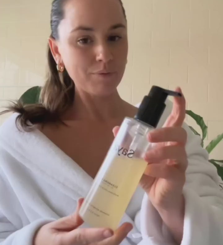 a woman using saya cleansing gel to wash her face