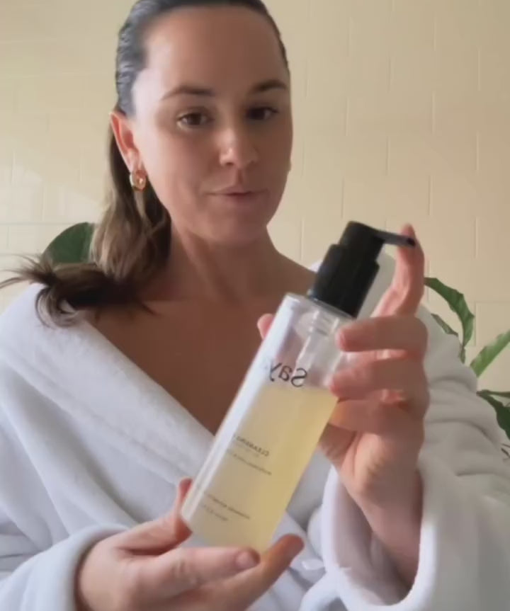 a woman using saya cleansing gel to wash her face