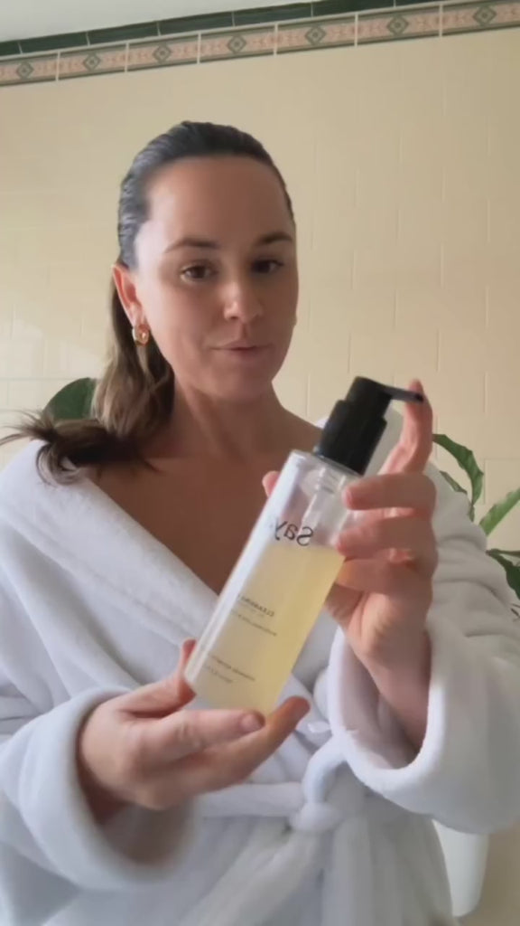 a woman using saya cleansing gel to wash her face