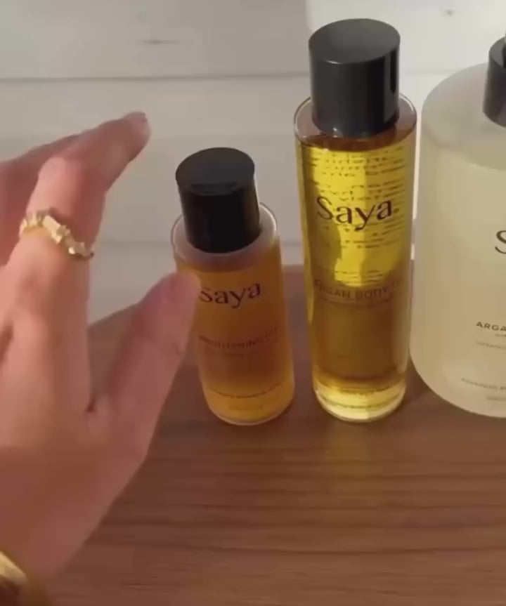 a woman using the glow and nourish duo made up of saya argan oil and saya brightening peel, for her hair