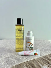 argan oil, apricot lotion and colourless lip balm on the table