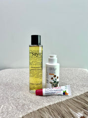 argan body oil, apricot lotion and tinted lipbalm on a table