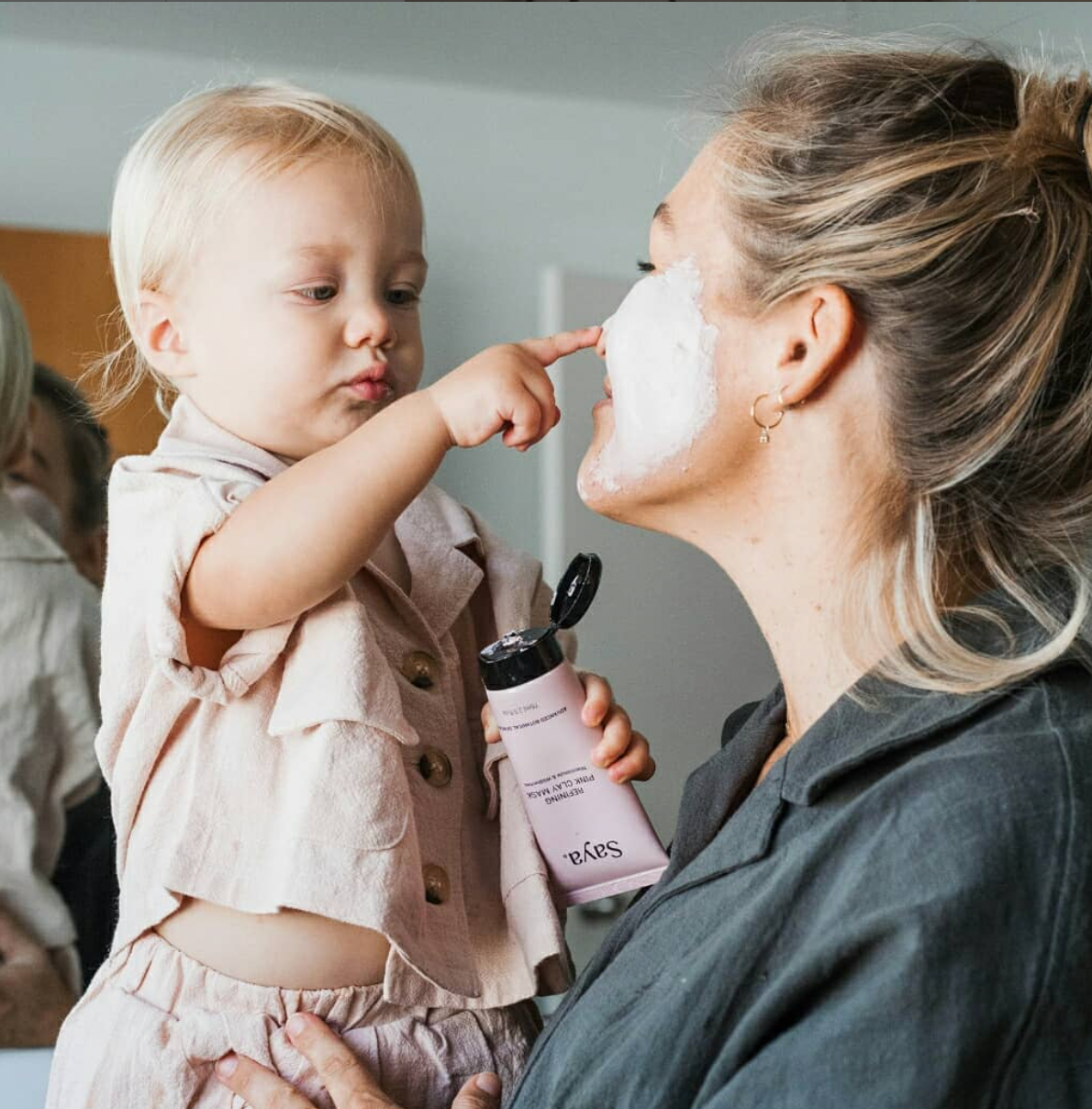 a child touching her mother's face