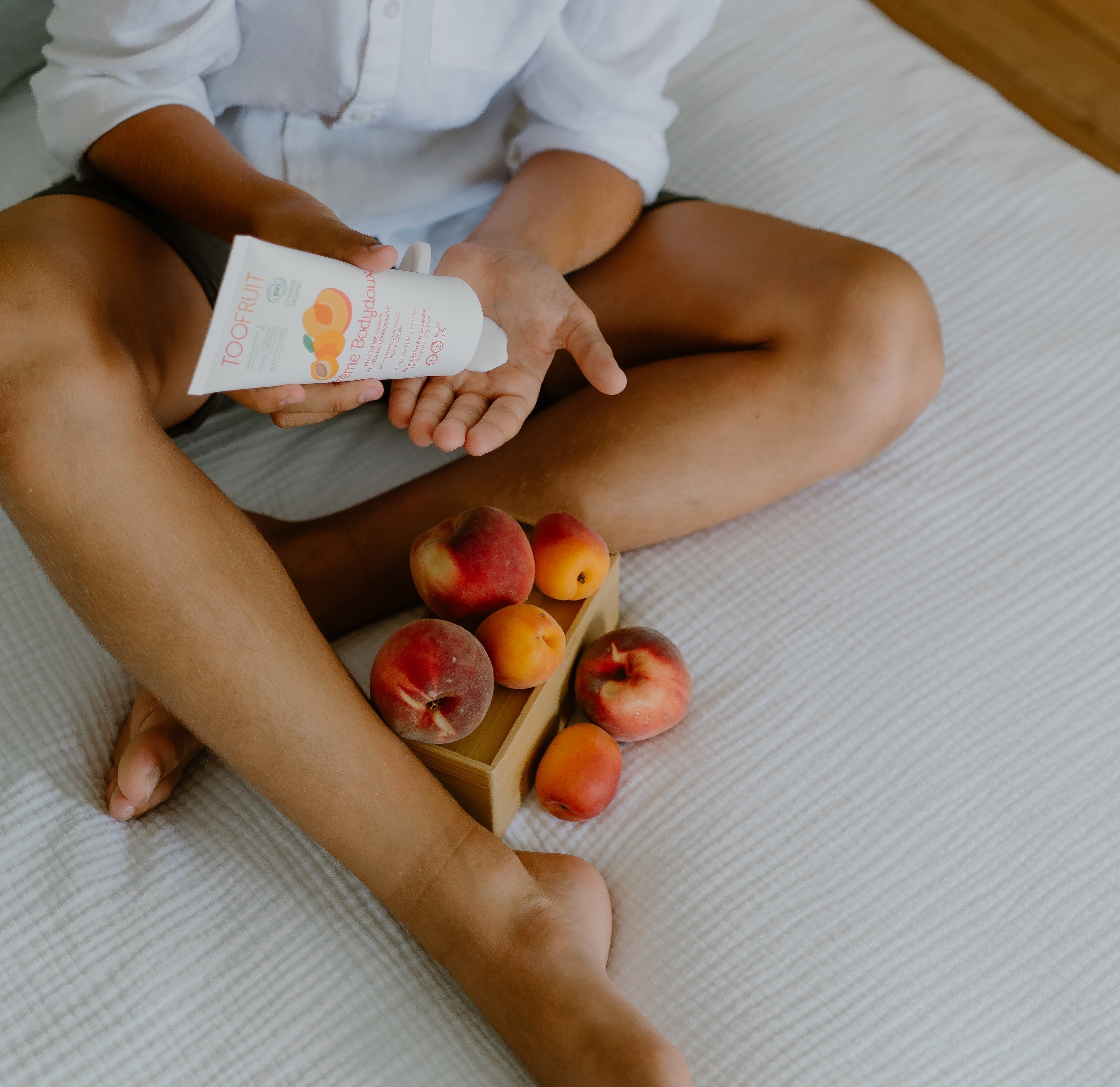 a boy squeezing cream on his palm