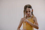 a girl combing her wet hair 