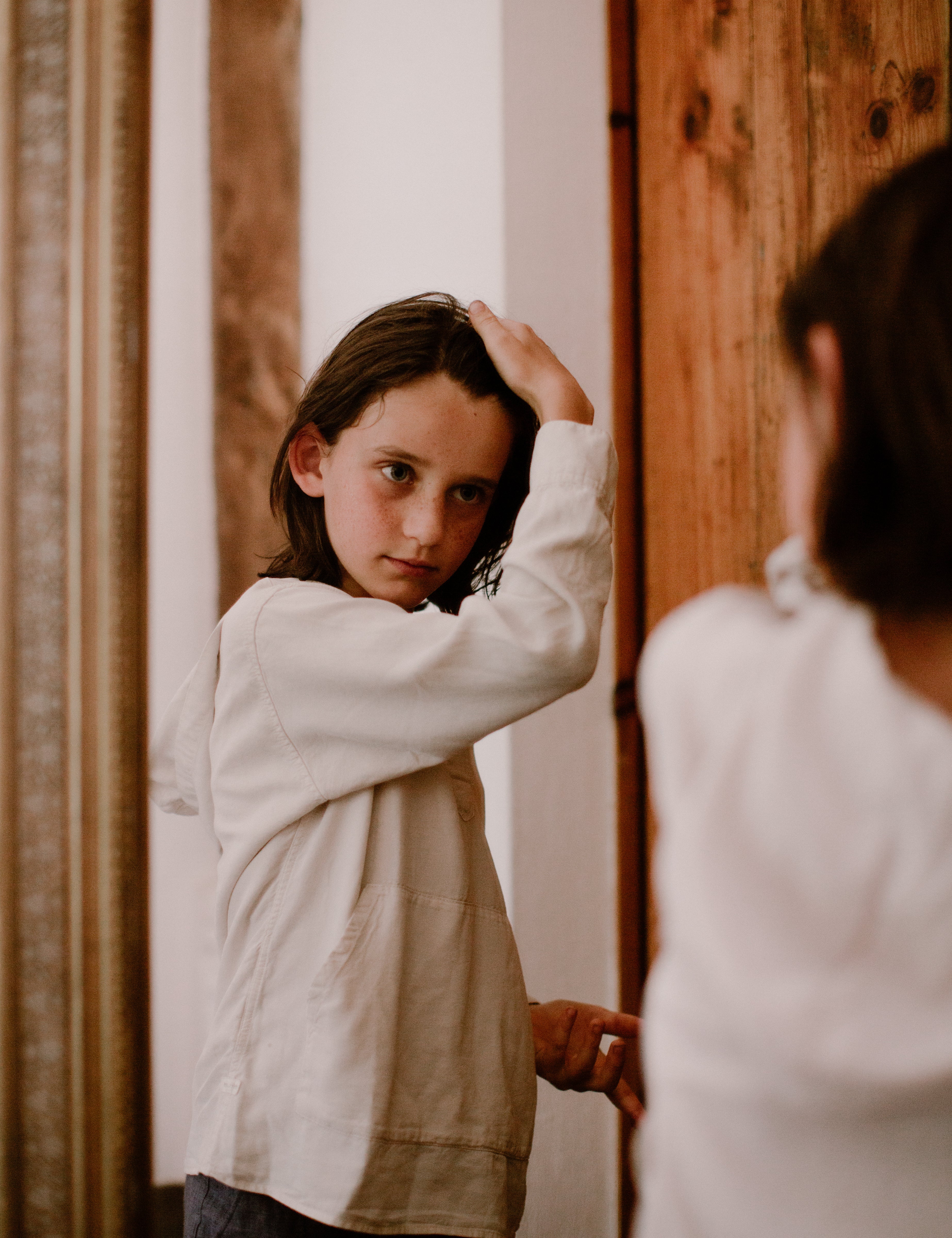 a boy using toofruit hair styling paste on his hair