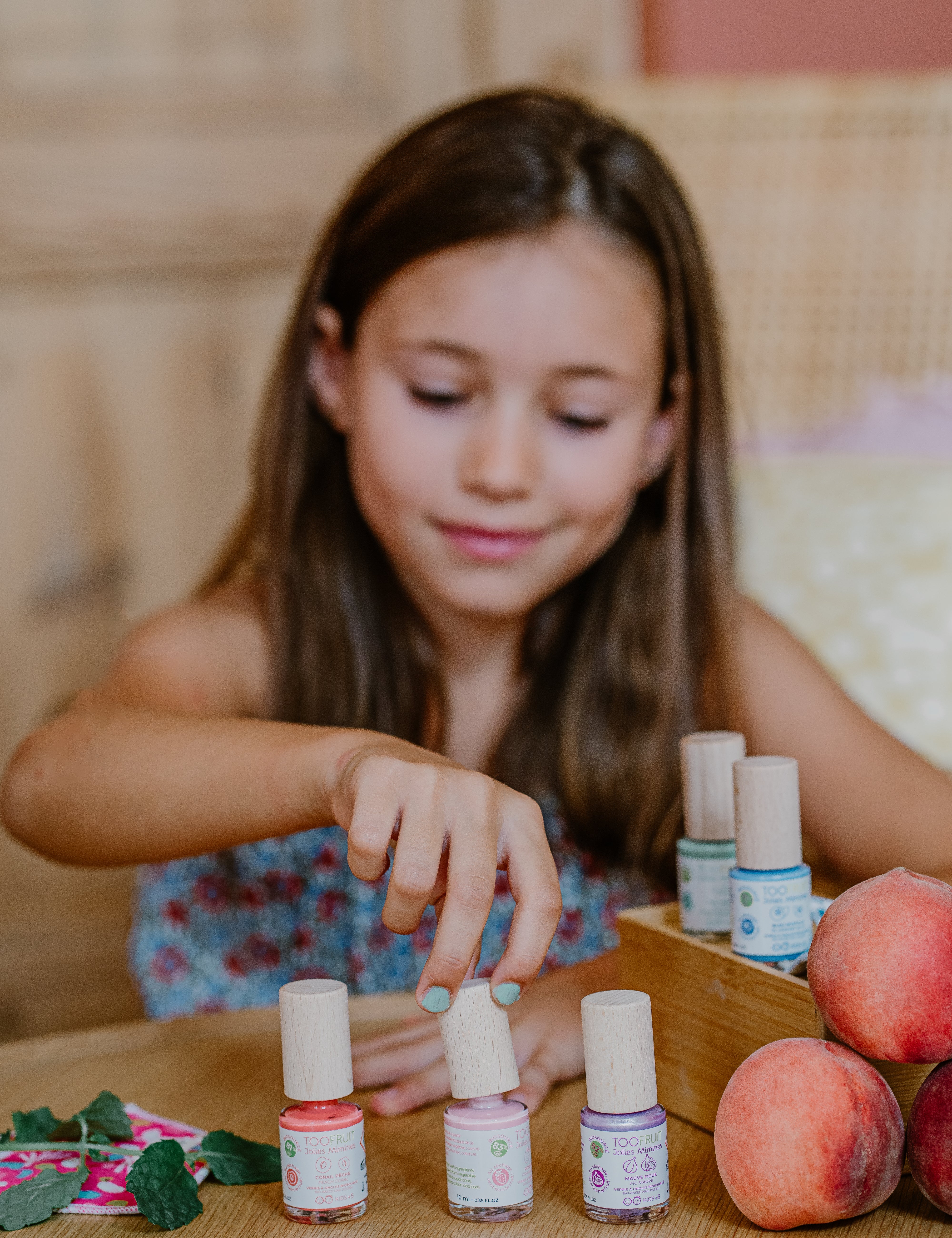 a girl using toofruit nail polish