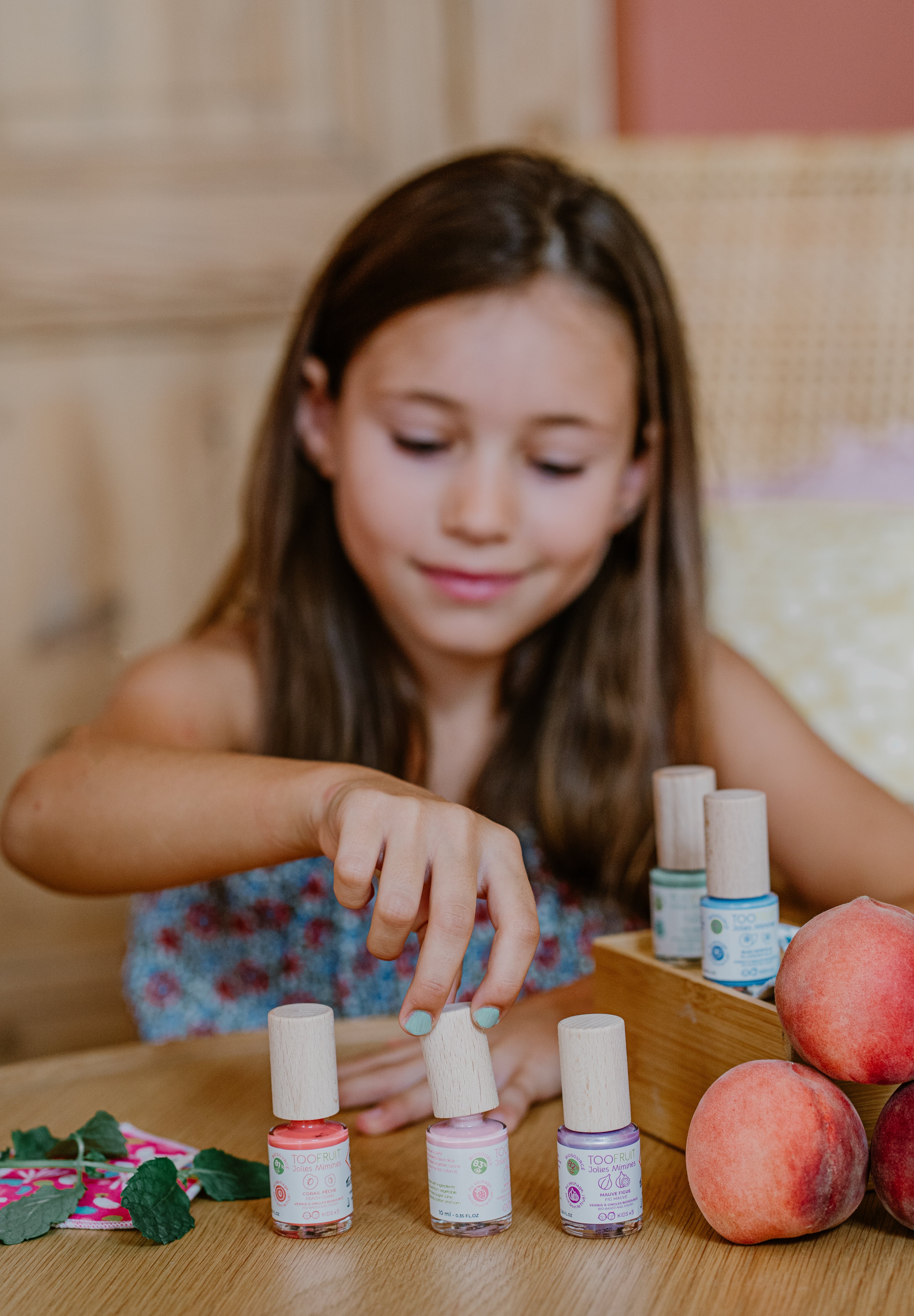 a girl using toofruit nail polish