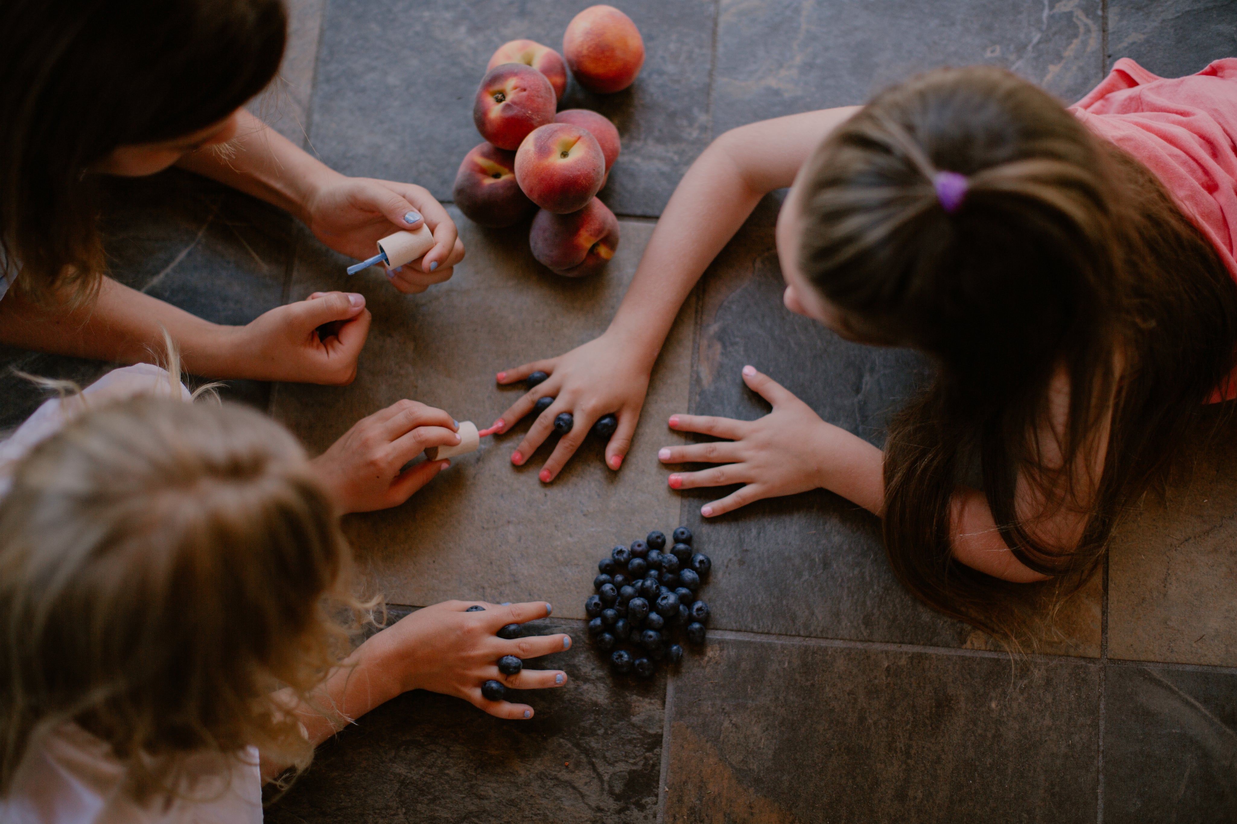 three girls painting their nails with toofruit nail polishes