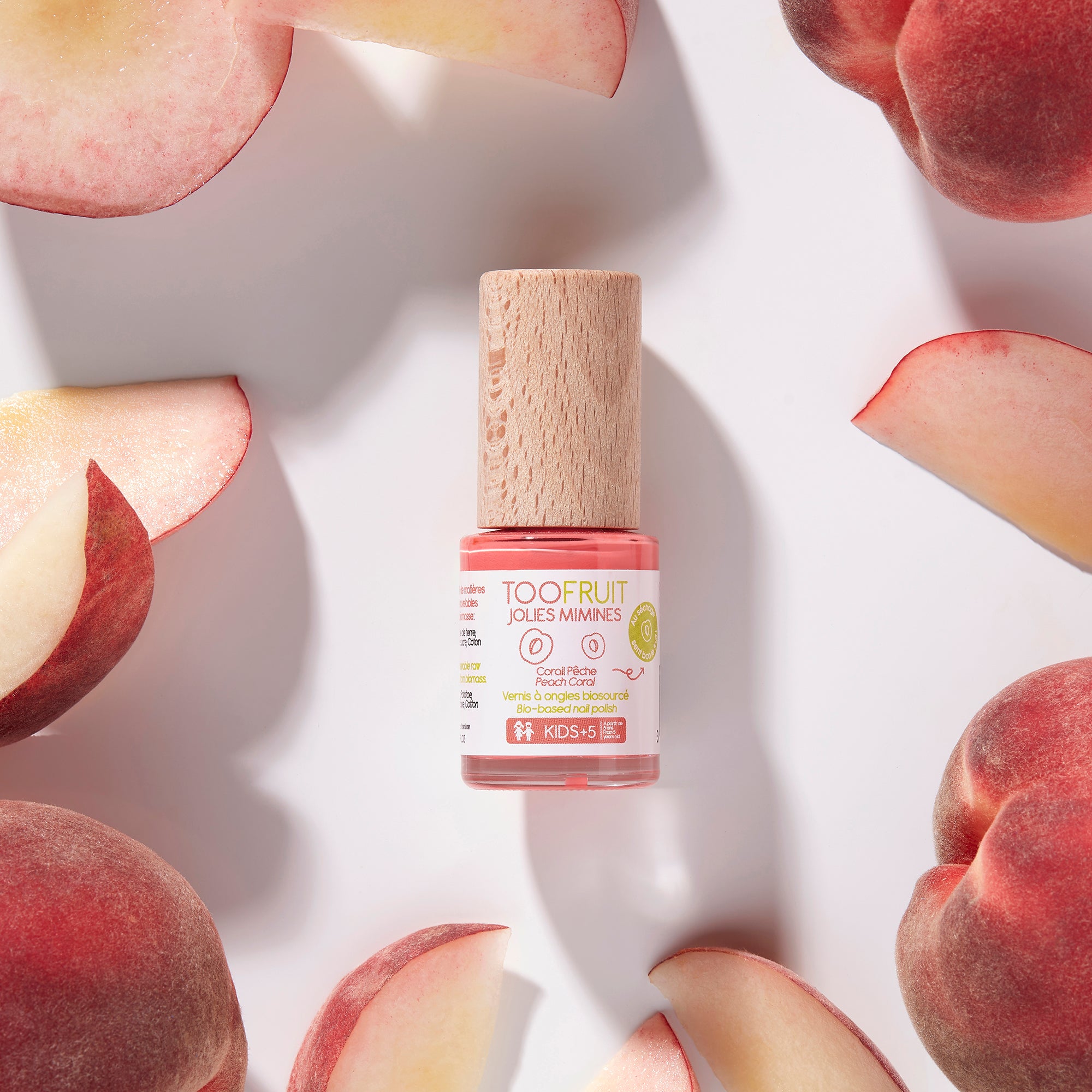 a bottle of toofruit peach nail polish and peaches