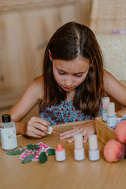a girl applying toofruit nail polish on her nails