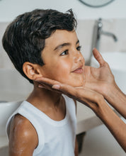 a boy with cream on his face and arm