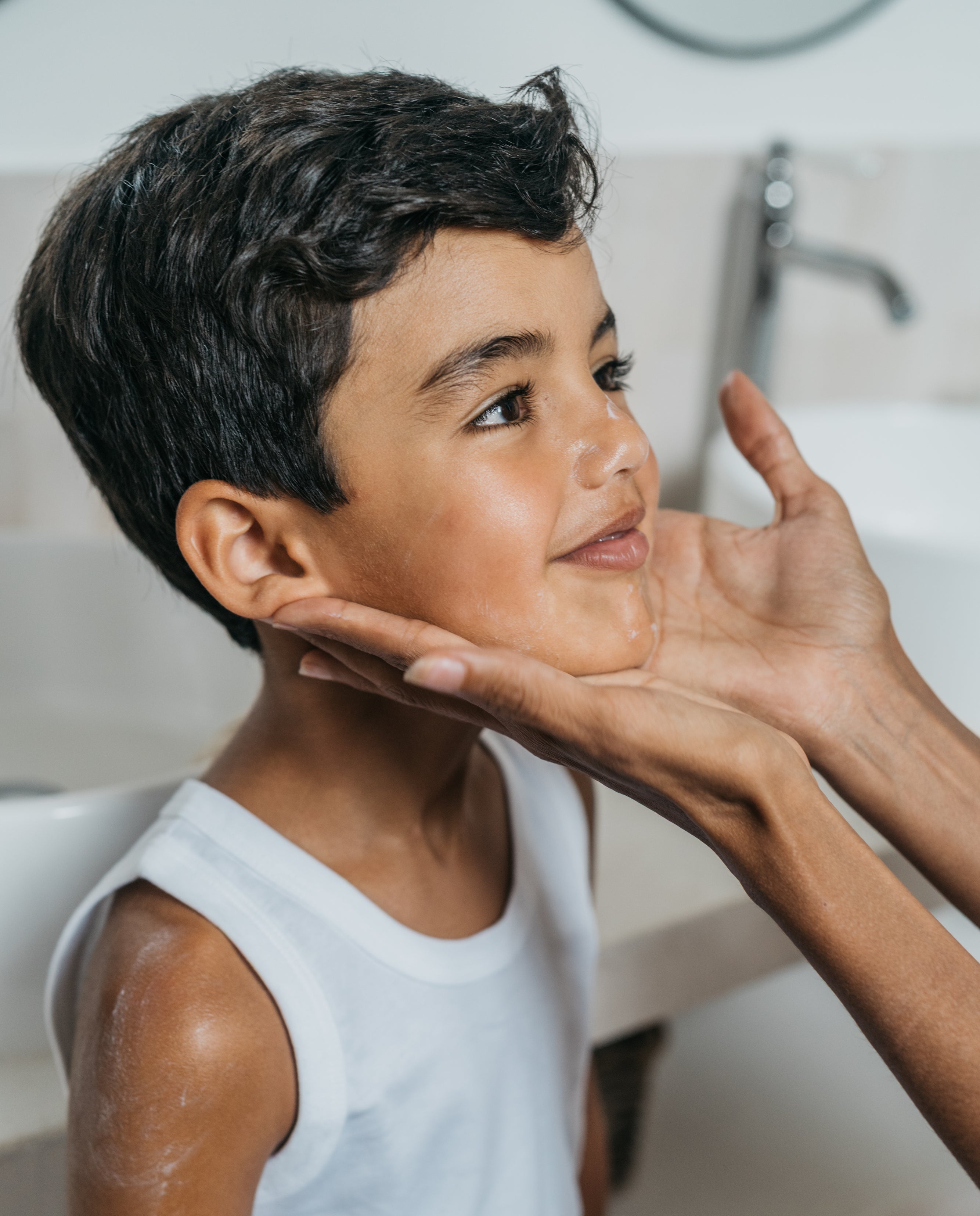 a boy with cream on his face and arm