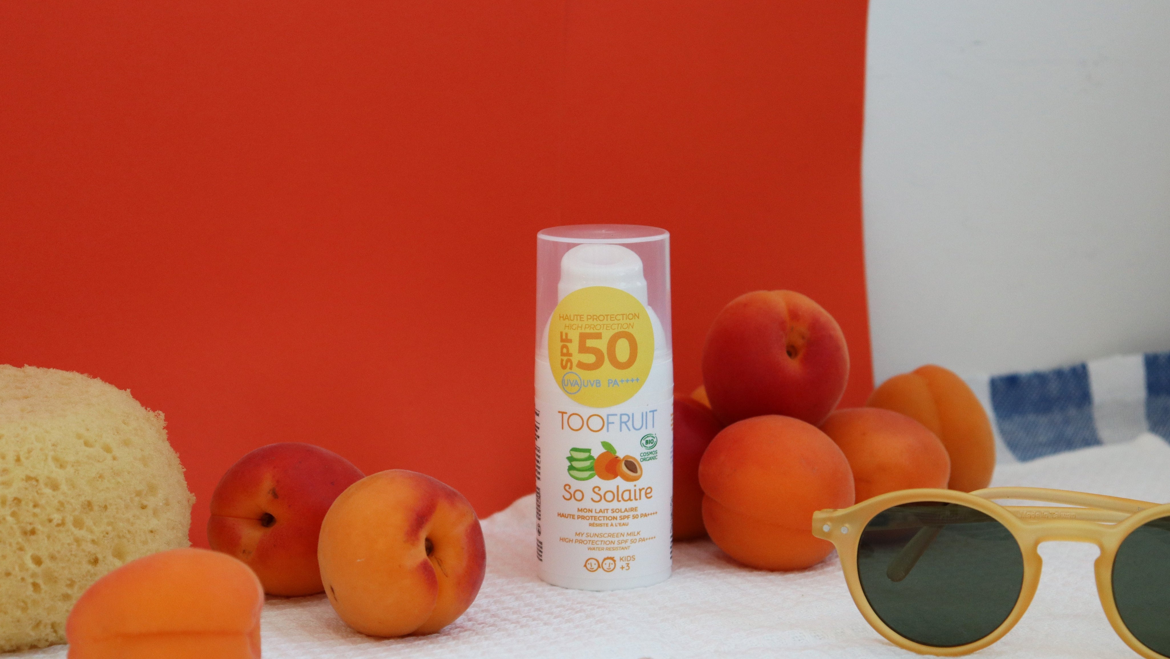 a bottle of sunscreen and fruits